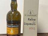 a bottle of wine sitting next to a box on a table