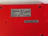 a close up of a red electronic device on a table