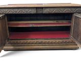 an image of a wooden cabinet with a door open and a red carpet underneath it