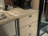 a small kitchen with a sink and a coffee maker in it