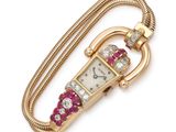 an image of a close up of a wrist watch with a chain