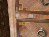 a wooden dresser with two drawers and a door handle