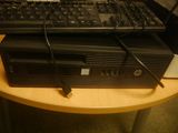 a black computer sitting on top of a wooden desk
