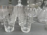 a lot of glasses and vases sitting on a table