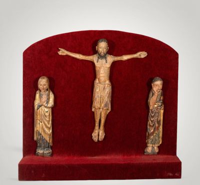 trois figurines de Jésus sur un socle rouge