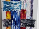 peinture représentant des formes abstraites sur une toile blanche posée sur un support en bois