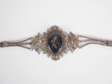 an image of a silver bracelet with a picture of a horse on it