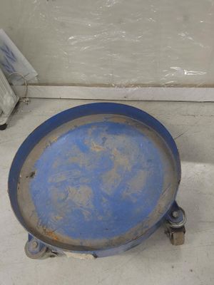 a blue plate sitting on the floor next to a toilet