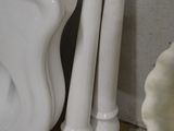 two white vases sitting next to each other on the floor
