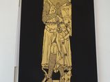 feuille d'or sur papier noir représentant la statue d'un homme tenant une épée