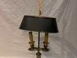 a lamp that is sitting on a table with a black shade