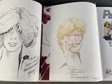 three pages of comic books on a table