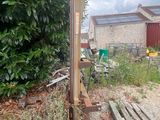 a wooden fence in the middle of a yard