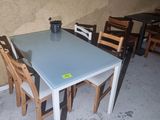 a glass table and chairs in a small room
