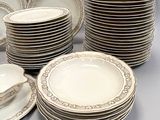 a lot of plates that are stacked together on the table