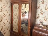 a bedroom with a bed, dresser, and mirror in it