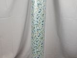 a tall vase with a blue and green design on it