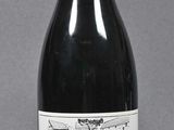 bottle of red wine on a gray surface with a gray background