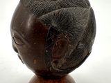 an image of a wooden sculpture of a woman ' s head on a stand