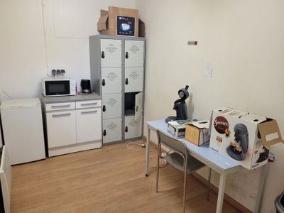 a small kitchen with a refrigerator and a microwave in it