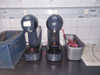 trois machines à café posées sur un plan de travail dans une cuisine