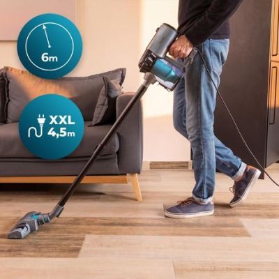 the man is cleaning the floor with a vacuum cleaner