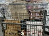 two dogs sitting in a cage on a cart