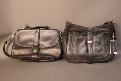 pair of black leather purses sitting next to each other on a table