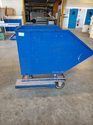 a blue dumpster sitting in a garage next to a building