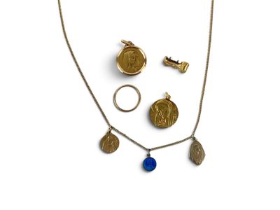 a close up of a necklace, ring, and other items on a white surface