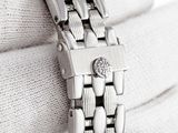 a close up of a silver watch on a white glove