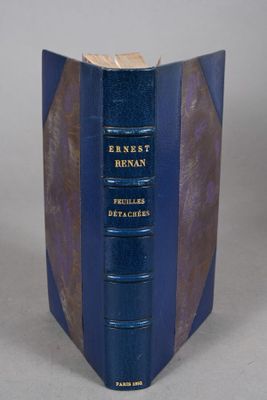 an old book with a blue cover sitting on top of a table