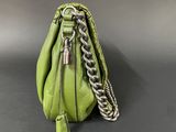 a green purse with a chain hanging from it