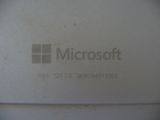 a close up of the microsoft logo on the back of a computer