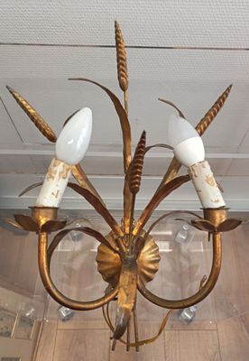 a chandelier with three lights hanging from it ' s ceiling