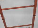 a wooden ladder that is leaning up against a wall
