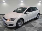 the white volkswagen golf is parked on a checkered tile floor