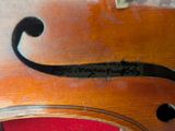 a close up of a violin that is on a table