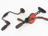pair of antique hand cranks on a white background