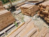 a lot of wood that is stacked up on the ground