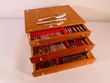three drawers with silverware in them on a white surface