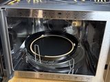 an image of a microwave with a black plate inside of it