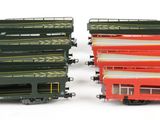 two red and green buses next to each other on a white surface