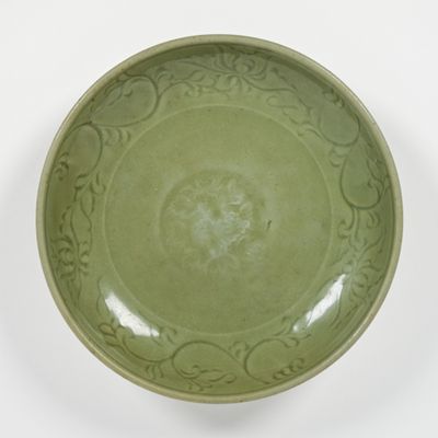 a green bowl with a decorative design on it