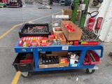 a blue cart with tools on it in a parking lot