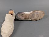 pair of men ' s slippers on grey surface with grey background