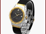 une image représentant une montre au cadran noir rehaussé de touches dorées