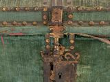 a green trunk that has a lock on it
