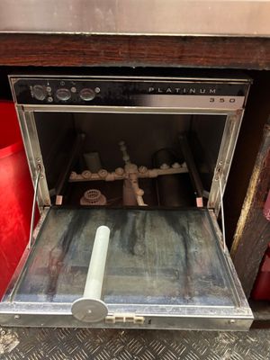 an open oven with a roll of paper inside of it