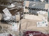 many bags of men ' s clothing on display in a store
